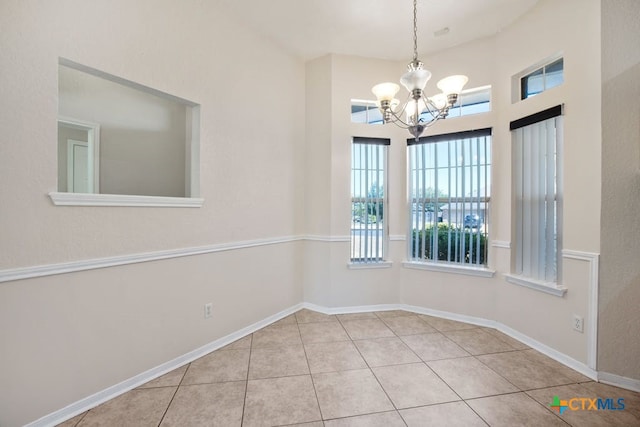 unfurnished dining area featuring an inviting chandelier and light tile patterned floors