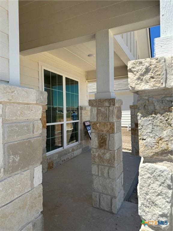 details with stone siding and ornate columns