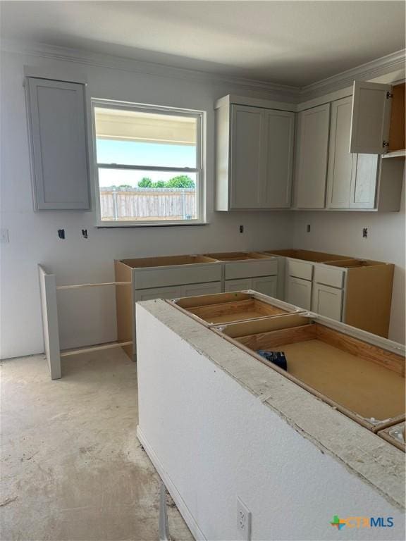 kitchen with gray cabinets and concrete flooring