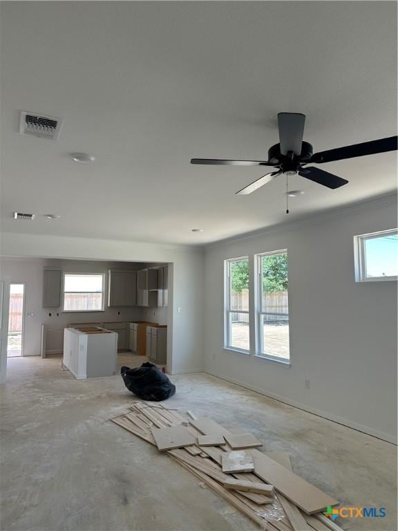 unfurnished living room featuring ornamental molding, concrete floors, a ceiling fan, and visible vents