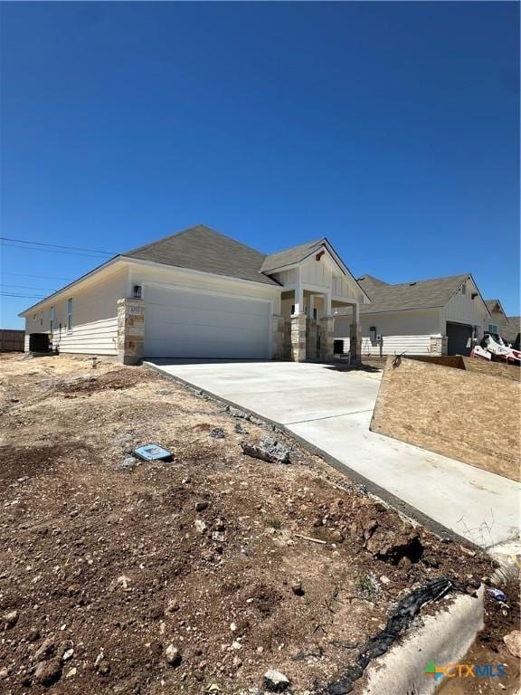 ranch-style house with a garage and driveway