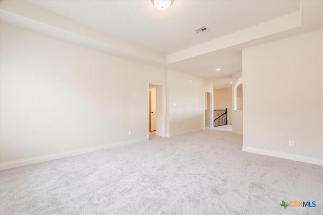 2933 Countryside Path, Seguin, TX 78155 - unfurnished room featuring light carpet, a tray ceiling, arched walkways, and recessed lighting