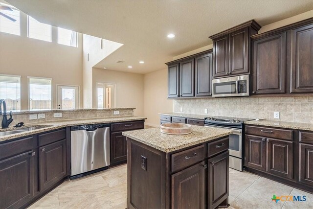2933 Countryside Path, Seguin, TX 78155 - kitchen with appliances with stainless steel finishes, plenty of natural light, decorative backsplash, light stone counters, and recessed lighting