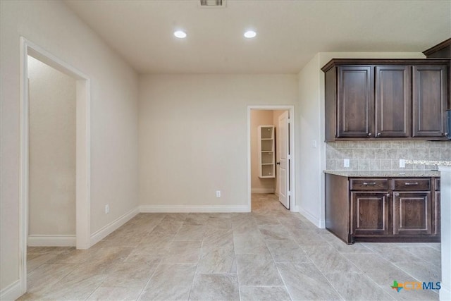 2933 Countryside Path, Seguin, TX 78155 - kitchen featuring dark brown cabinetry, backsplash, recessed lighting, and light stone countertops