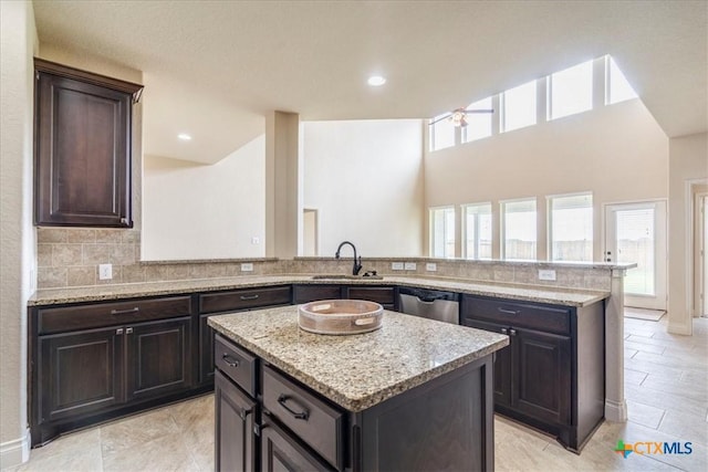 2933 Countryside Path, Seguin, TX 78155 - kitchen with healthy amount of natural light, light stone countertops, dishwasher, and a kitchen island