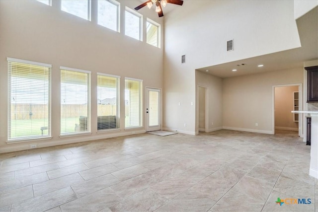 2933 Countryside Path, Seguin, TX 78155 - unfurnished living room featuring a ceiling fan, a towering ceiling, and light tile patterned floors