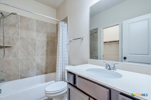 2933 Countryside Path, Seguin, TX 78155 - bathroom featuring vanity, shower / tub combo with curtain, and a textured wall