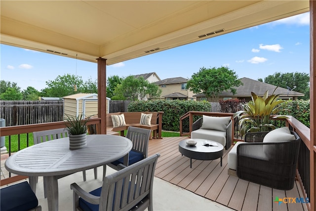 929 Darion St, New Braunfels, TX 78130 - wooden deck featuring a storage unit, outdoor lounge area, an outdoor structure, outdoor dining area, and a fenced backyard