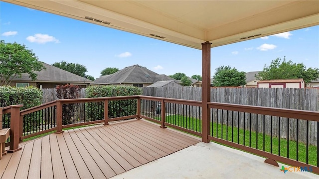 wooden deck featuring a fenced backyard and visible vents