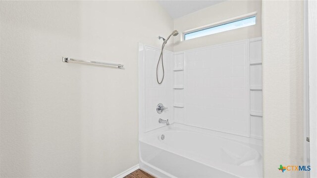 929 Darion St, New Braunfels, TX 78130 - full bathroom featuring wood finished floors,  shower combination, and baseboards