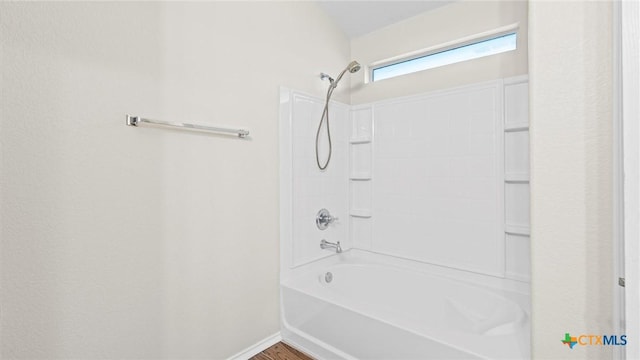 bathroom featuring  shower combination, baseboards, and wood finished floors