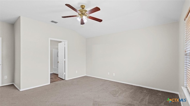 unfurnished bedroom featuring ceiling fan, visible vents, baseboards, lofted ceiling, and carpet flooring