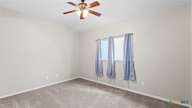 carpeted spare room with baseboards, ceiling fan, and lofted ceiling