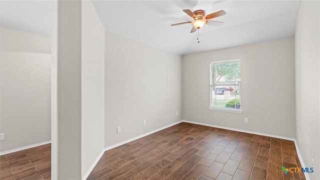 empty room featuring baseboards, ceiling fan, wood finished floors, and lofted ceiling