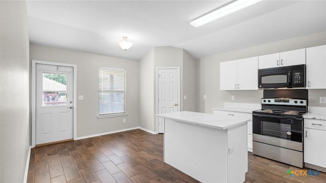 kitchen featuring white cabinets, stainless steel electric range, black microwave, lofted ceiling, and a kitchen island