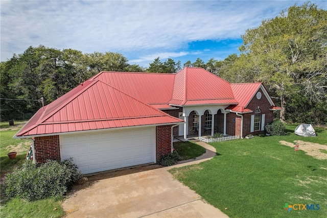 1495 Makinson Rd, La Grange, TX 78963 - view of front of home with a front lawn, brick siding, metal roof, and concrete driveway