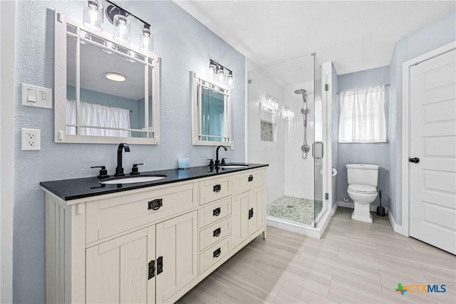 1213 Indian Trl, Salado, TX 76571 - bathroom featuring a shower stall, double vanity, and a textured wall