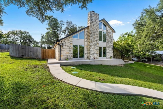 1213 Indian Trl, Salado, TX 76571 - back of property with stone siding, a chimney, and a gate