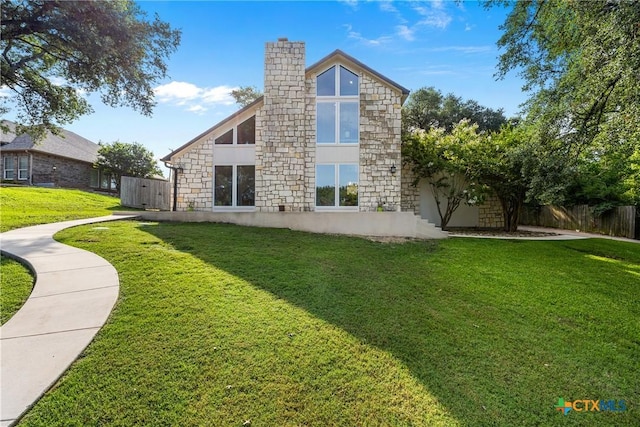 1213 Indian Trl, Salado, TX 76571 - back of house with stone siding and a chimney