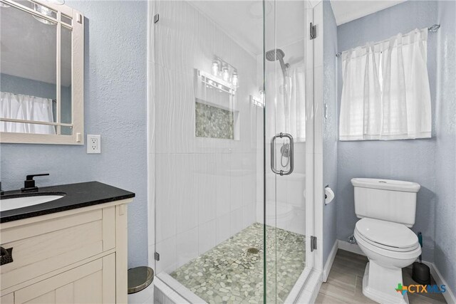 1213 Indian Trl, Salado, TX 76571 - full bath with a shower stall, vanity, wood finished floors, and healthy amount of natural light