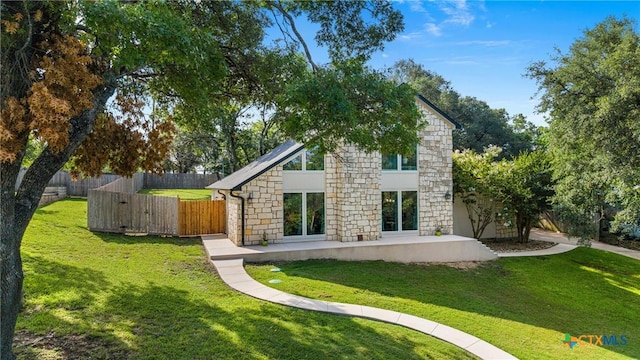 1213 Indian Trl, Salado, TX 76571 - back of property featuring stone siding and a patio