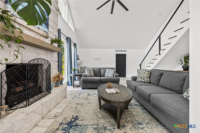 1213 Indian Trl, Salado, TX 76571 - living area with high vaulted ceiling, a stone fireplace, stairway, and a ceiling fan