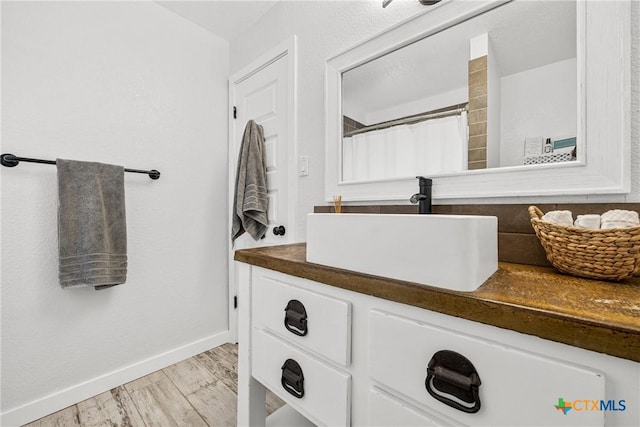 1213 Indian Trl, Salado, TX 76571 - bathroom featuring vanity, wood finished floors, and curtained shower
