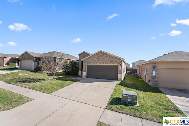 ranch-style home featuring a front yard, cooling unit, and a garage