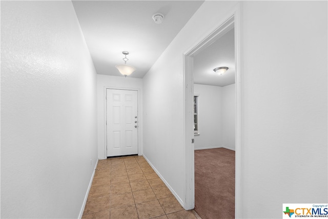 entryway with light colored carpet