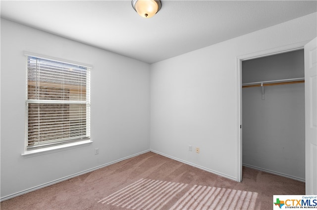 unfurnished bedroom featuring a closet and carpet floors