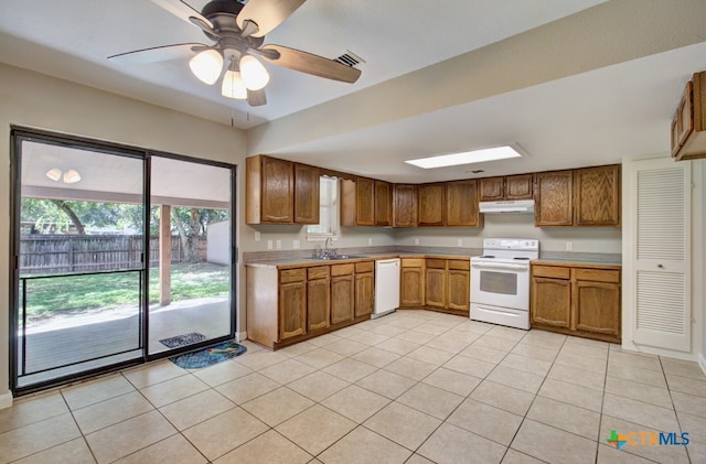 kitchen featuring white appliances, ceiling fan, light tile patterned floors, and sink