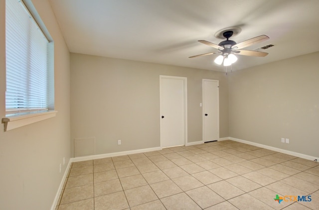 unfurnished room featuring light tile patterned floors and ceiling fan