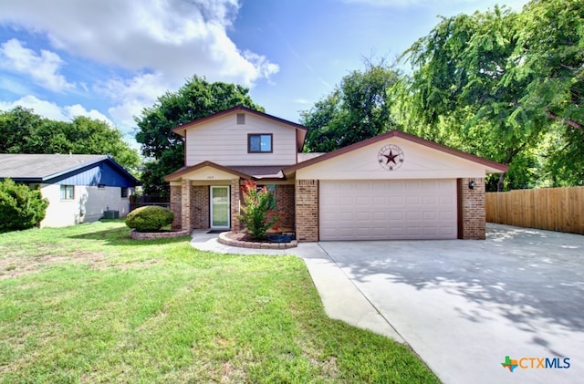 view of front of home with a garage, central AC, and a front yard