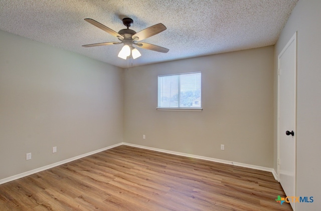 unfurnished room featuring ceiling fan, a textured ceiling, and light hardwood / wood-style flooring