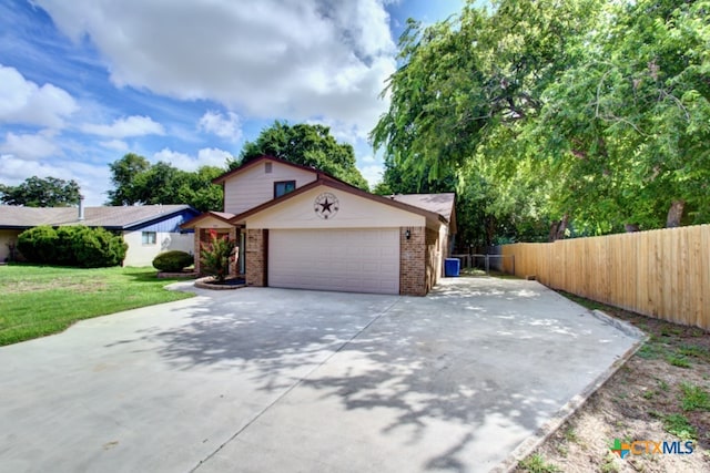 view of front of property with a garage and a front lawn