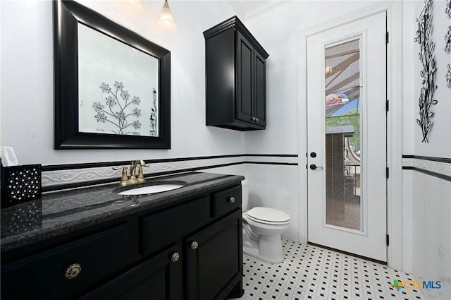 201 County Road 156, Georgetown, TX 78626 - bathroom with tile walls, vanity, toilet, and wainscoting