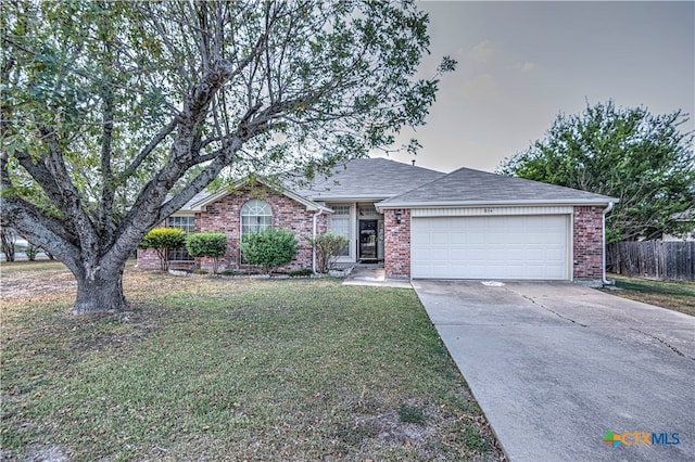 single story home with a front lawn and a garage