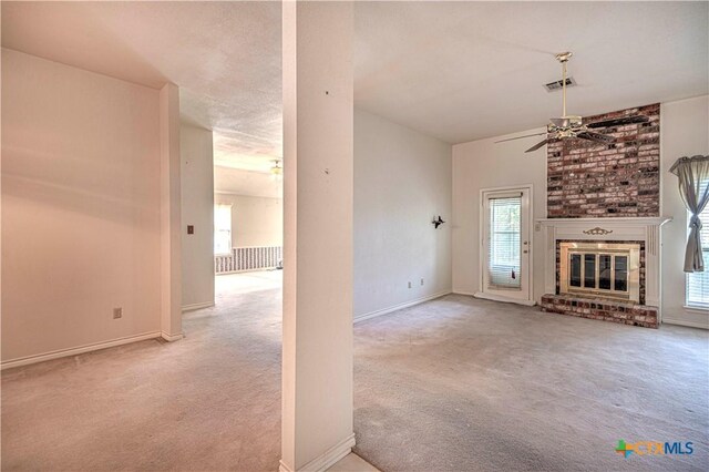 614 Sabine Cir, Temple, TX 76504 - unfurnished living room featuring carpet flooring, ceiling fan, a fireplace, and baseboards