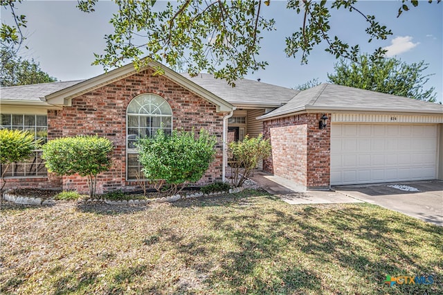 single story home featuring a garage and a front yard