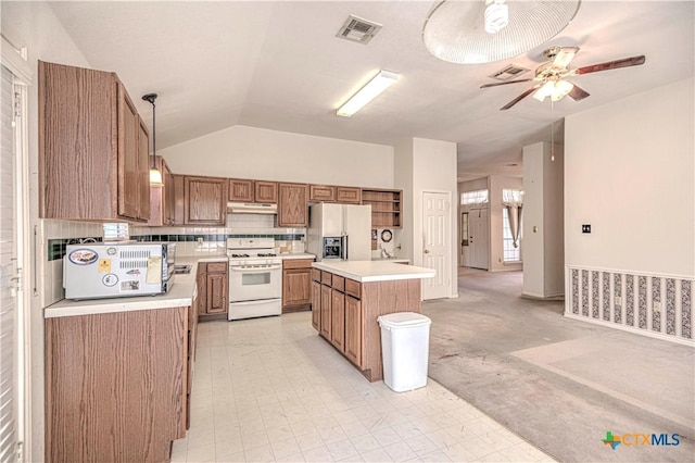 614 Sabine Cir, Temple, TX 76504 - kitchen featuring white appliances, light countertops, ceiling fan, lofted ceiling, and a center island