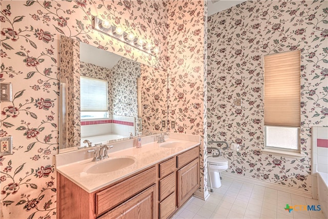 bathroom with toilet, a tub, tile patterned floors, and plenty of natural light