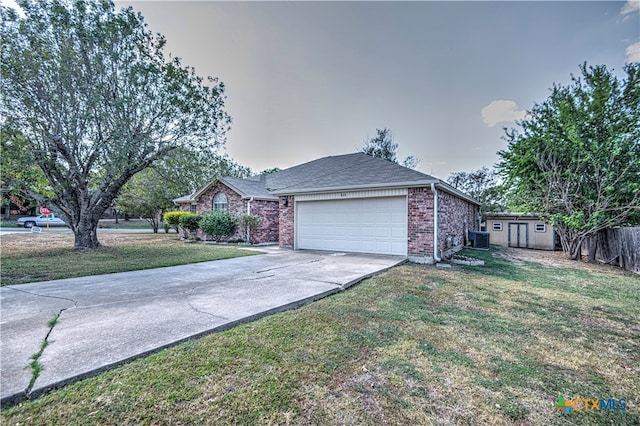 single story home featuring a garage, central AC unit, and a front yard