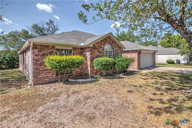 614 Sabine Cir, Temple, TX 76504 - ranch-style house featuring driveway, brick siding, a garage, and roof with shingles