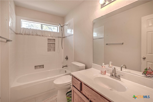 full bathroom with vanity, toilet, and tiled shower / bath combo