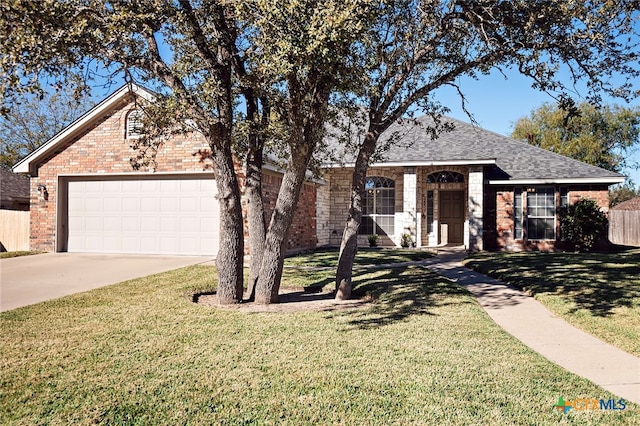 ranch-style house featuring a garage and a front lawn