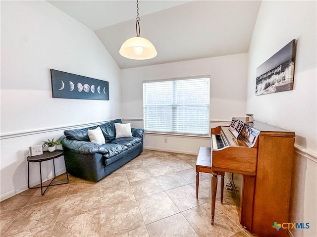 living area featuring tile patterned flooring, baseboards, and lofted ceiling