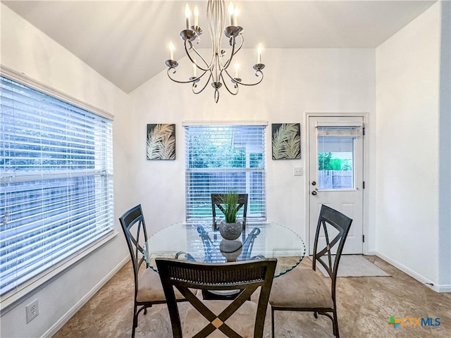 dining area featuring lofted ceiling, baseboards, and a chandelier