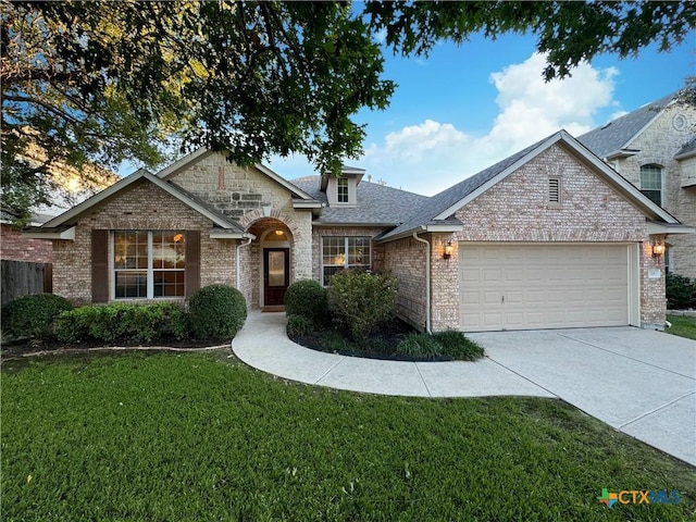 view of front of house with driveway, an attached garage, a shingled roof, a front lawn, and stone siding