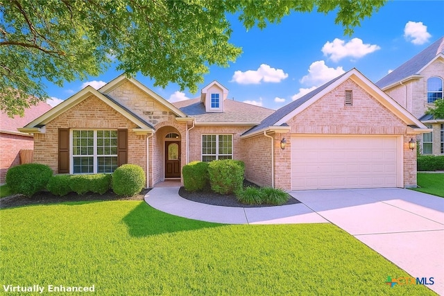 715 S Frontier Ln, Cedar Park, TX 78613 - traditional-style home featuring a garage, a front yard, brick siding, and driveway