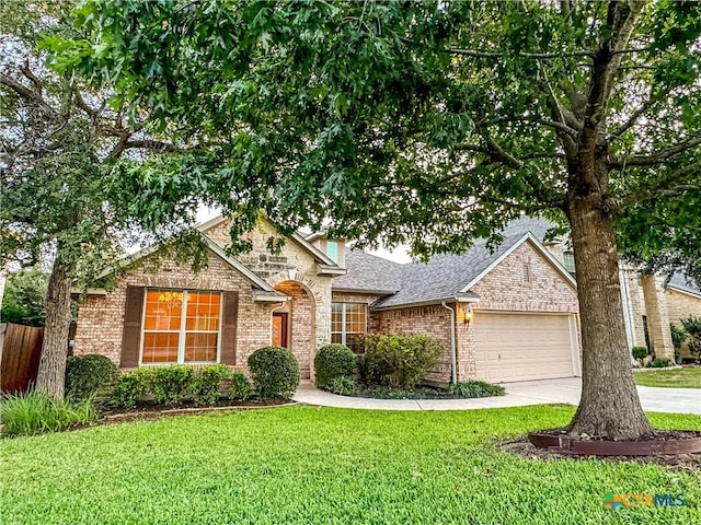 view of front of house featuring a front lawn, a garage, brick siding, and concrete driveway